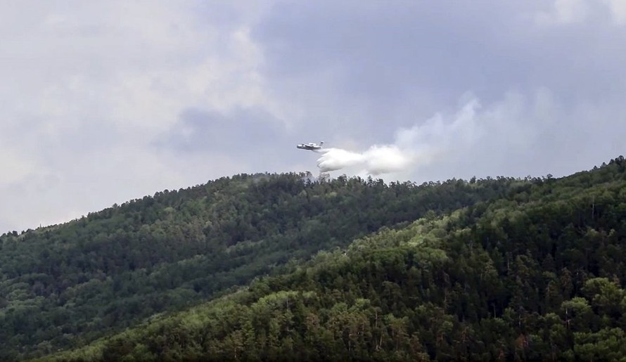 Ngày 10-7, một chiếc máy bay đổ bộ đa năng BE-200 Be-200 của Bộ khẩn cấp Nga phun nước trong Công viên quốc gia Trans-Baikal ở Buryatia, miền nam Siberia, Nga. Ảnh cắt từ video do Bộ khẩn cấp Nga cung cấp.