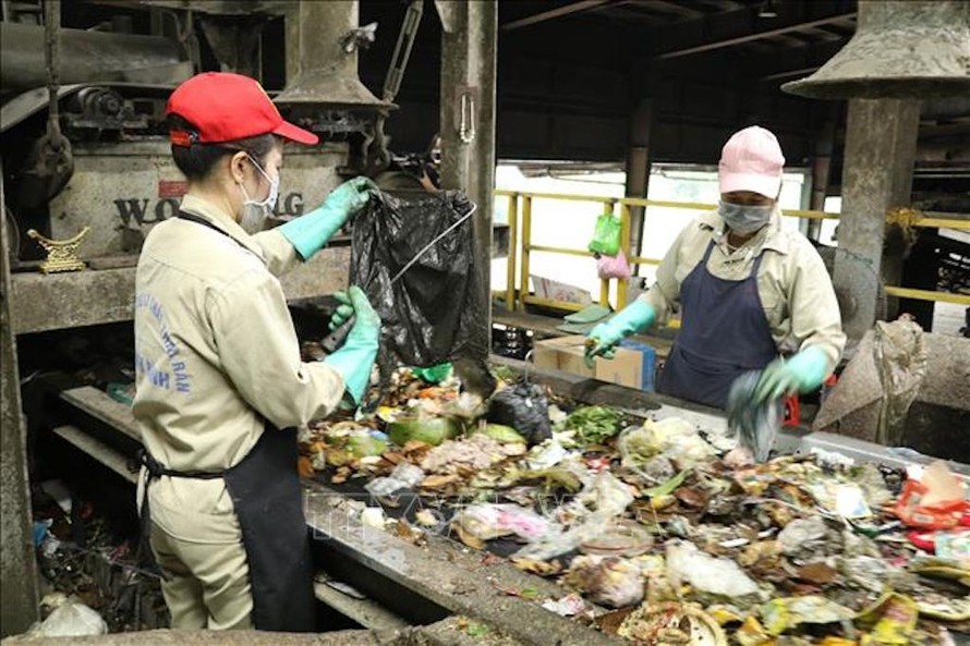 Công nhân phân loại rác tại dây chuyền xử lý rác thành phân bón hữu cơ tại Nhà máy xử lý chất thải rắn Ninh Bình. 