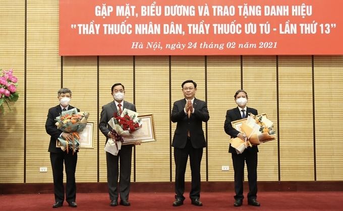 Bí thư Thành ủy Hà Nội Vương Đình Huệ trao danh hiệu "Thầy thuốc nhân dân" cho các cá nhân. (Ảnh: Báo điện tử Đảng Cộng sản)