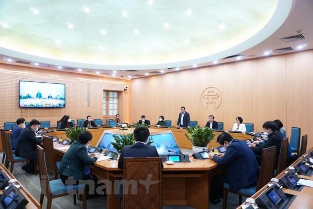 Các đại biểu tham dự cuộc họp của Ban Chỉ đạo phòng, chống dịch COVID-19 thành phố Hà Nội với các quận, huyện. (Ảnh: PV/Vietnam+)