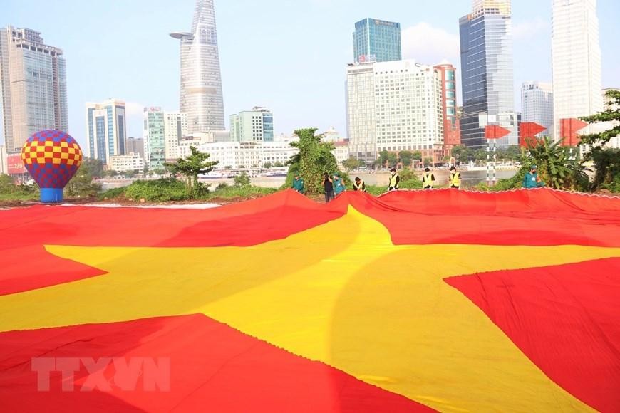 Lá đại kỳ dài 60m, rộng 30m (diện tích 1.800m2) được chuẩn bị sẵn sàng kéo lên bầu trời Thành phố Hồ Chí Minh trong sáng 2/9. (Ảnh: Thu Hương/TTXVN) 