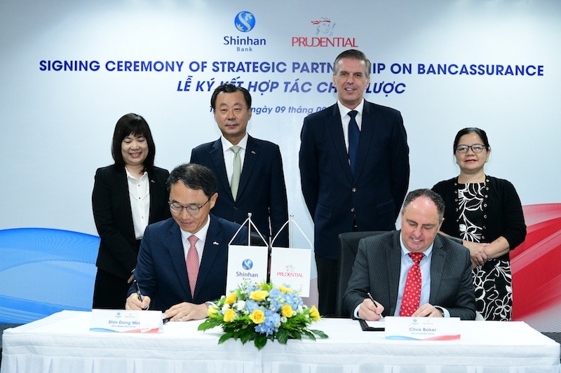 Ông Shin Dong Min -Tổng Giám đốc của Ngân hàng Shinhan tại Việt Nam và ông Clive Baker -Tổng Giám đốc Prudential Việt Nam ký kết thỏa thuận Hợp tác chiến lược dưới sự chứng kiến của đại diện hai doanh nghiệp.