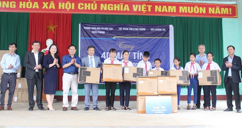  Đại diện Tập đoàn Tân Á Đại Thành trao máy tính cho các trường học trên địa bàn huyện Triệu Phong - Ảnh: Thanh Trúc