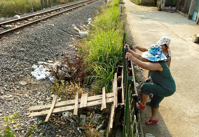 Người dân ở ấp Ngũ Phúc, xã Hố Nai 3, huyện Trảng Bom (Đồng Nai) chế thang vượt hành lang đường sắt.
