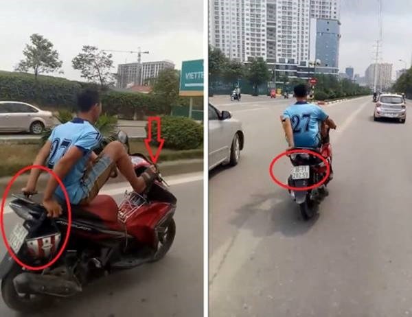 Nam thanh niên liều lĩnh lái xe máy bằng chân, đầu trần đi vào làn BRT. (Ảnh: Cộng tác viên)