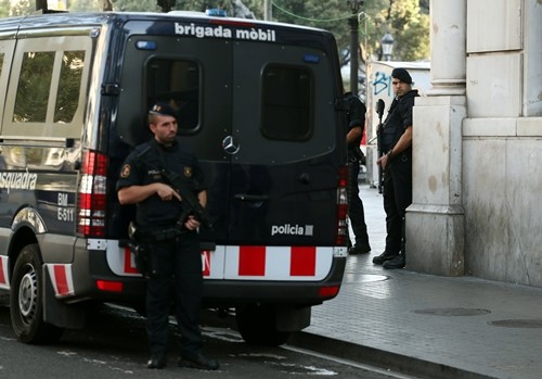 Lực lượng vũ trang Catalan đứng gác trên phố Las Ramblas, nơi xe tải mini đâm vào người đi bộ ở Barcelona. Ảnh: Reuters. 