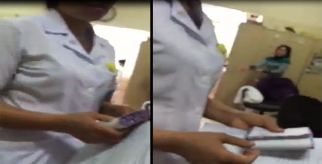 Nữ nhân viên y tế nhận cả xấp phong bì bị phát hiện tại Bệnh viện K hồi tháng 6. Ảnh: Cắt từ clip.