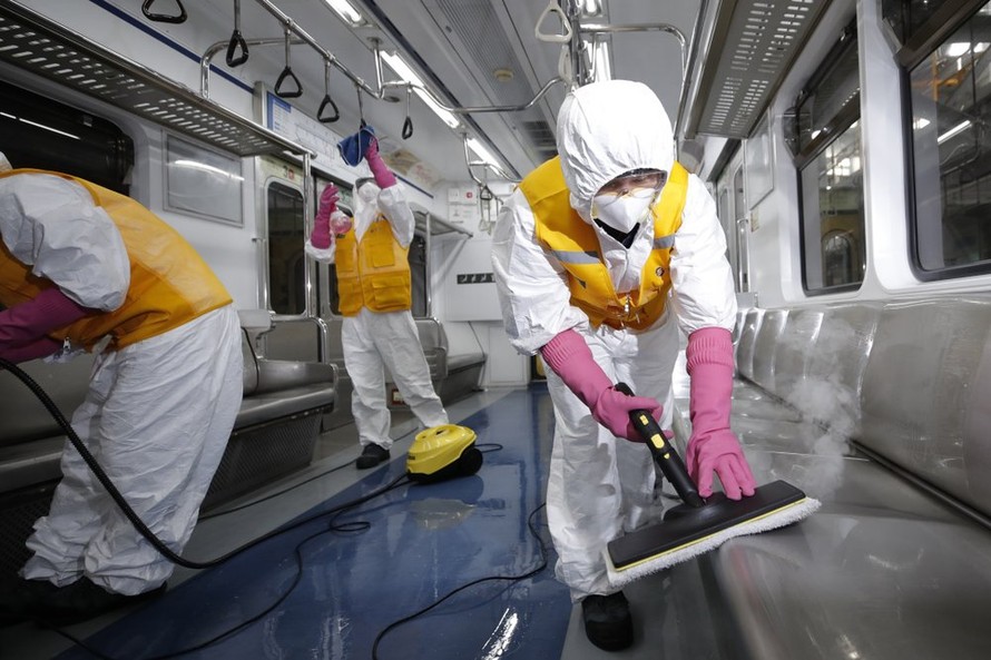Các nhân viên vệ sinh đang lau chùi một toa tàu điện ngầm ở Seoul, Hàn Quốc. Ảnh: AP