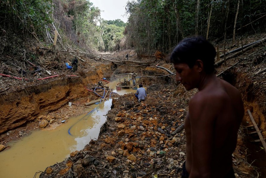 Một thổ dân Yanomami đang đứng bên một bãi khai thác vàng trái phép tại Roraima, Brazil vào ngày 17/4/2016. Ảnh: REUTERS