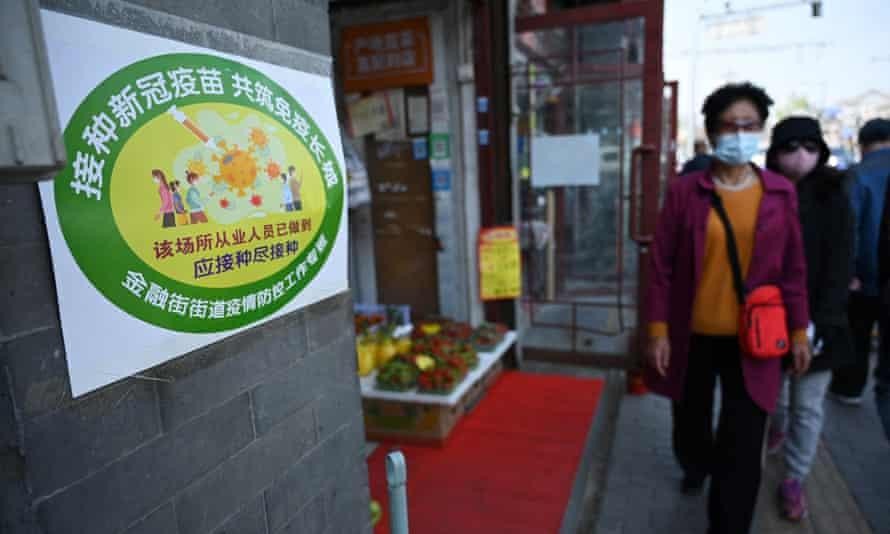 Một cửa hàng trái cây được dán nhãn xanh lá, cho thấy mọi nhân viên tại đây đã được tiêm chủng. Ảnh: AFP