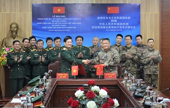 Đại diện Bộ Quốc phòng Việt Nam và Bộ Quốc phòng Trung Quốc trao đổi Biên bản ký kết bàn giao tại Lễ bàn giao trang thiết bị y tế phòng chống, dịch Covid-19 do Bộ Quốc phòng Việt Nam tặng Bộ Quốc phòng Trung Quốc diễn ra ngày 22-2