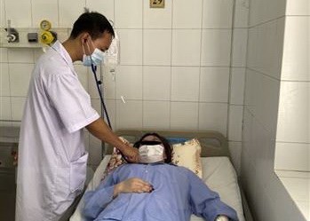 Bác sỹ thăm khám cho bệnh nhân Nguyễn Thị Thùy D. (Ảnh: TTXVN)