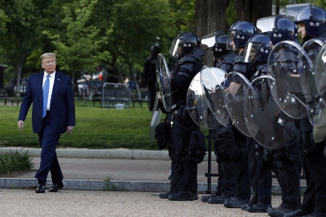 Tổng thống Trump đi qua lực lượng cảnh sát ở quảng trường Lafayette sau khi thăm nhà thờ vào ngày 1/6. Ảnh: AP.