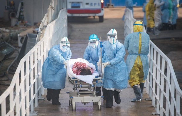 Nhân viên y tế chuyển bệnh nhân nhiễm virus corona chủng mới tới điều trị tại bệnh viện dã chiến Hỏa Thần Sơn ở Vũ Hán. (Ảnh: THX/TTXVN)