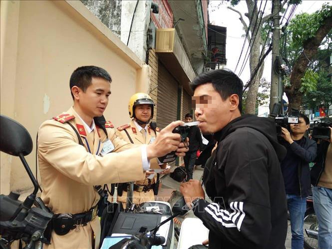 Lực lượng chức năng tiến hành đo nồng độ cồn đối với người điều khiển phương tiện vi phạm tại nút giao thông Hàng Cót - Phan Đình Phùng (Hà Nội).