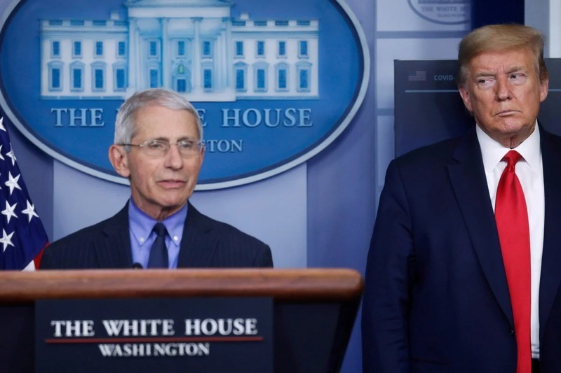 Chuyên gia chống Covid-19 hàng đầu Mỹ Anthony Fauci trả lời các câu hỏi trong một cuộc họp báo tại Nhà Trắng khi Tổng thống Trump đứng bên cạnh lắng nghe. Ảnh: Reuters