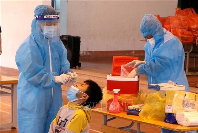 Nhân viên y tế Phú Thọ tổ chức lấy mẫu xét nghiệm lần 3 cho học sinh Trường tiểu học Bạch Hạc. Ảnh: Trung Kiên/TTXVN